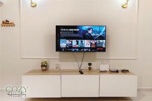 TV en una pared blanca en la sala de estar en Cozy~French Style@Game, Neflix, Water Dispenser, en Keluang