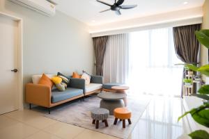 a living room with a couch and a table at Zenstay Abnb Perai Penang in Bukit Mertajam