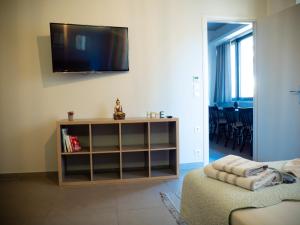 a living room with a flat screen tv on the wall at Modern apartment ATG in Athens