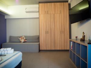 a bedroom with a bed and a wooden cabinet at Modern apartment ATG in Athens