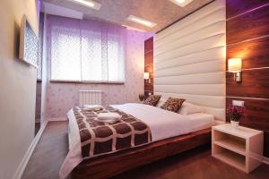 a bedroom with a large bed and a window at Apartments Belgrade in Belgrade +164 photos