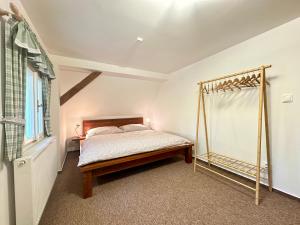 a bedroom with a bed and a window at Cottage Janovice in Rudník