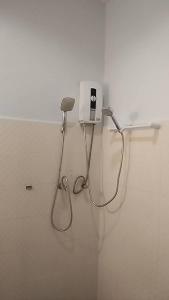 a bathroom with a blow dryer on a wall at เขาหลัก ซัมเมอร์เฮาส์ 2 in Khao Lak