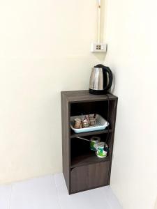 a small cabinet with a tea kettle on top of it at Captain Budget Guesthouse กัปตันเกสต์เฮาส์ in Ko Lipe