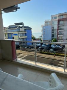 a balcony with a view of a parking lot with cars at Sea Dreams in Nesebar