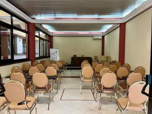 a room with a bunch of chairs and a podium at Ares Hotel in San Giovanni la Punta