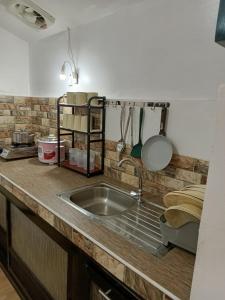 a kitchen with a sink and a counter top at Elisha's Guest House in Coron