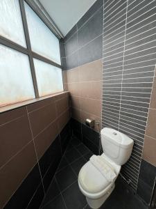 a bathroom with a toilet and a window at Hotel Economy Kapar in Kapar +13 photos