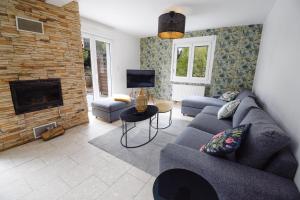a living room with a couch and a fireplace at Vacance au Bonhomme in Le Bonhomme