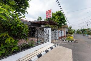 un restaurant avec un portail sur le côté d'une rue dans l'établissement RedDoorz at Osuko Residence Sukomanunggal Jaya, à Surabaya