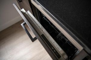 a close up of an oven with its door open at 20, Nestled in the woods, Big Chalet and Garden! in Oisterwijk