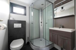 a bathroom with a shower and a toilet and a sink at 20, Nestled in the woods, Big Chalet and Garden! in Oisterwijk +30 photos