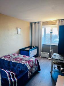 a bedroom with a bed and a large window at Booking in Clichy