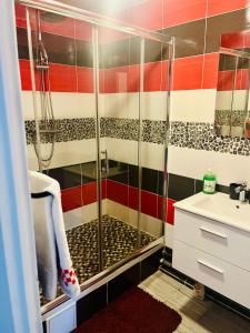 a bathroom with a shower and a sink at Booking in Clichy