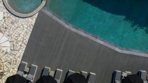 an overhead view of a swimming pool with chairs at Paros Agnanti Resort & Spa in Parikia