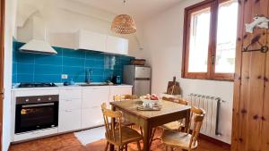 a kitchen with a table and a dining room at Casa Bedda in Agnone Bagni