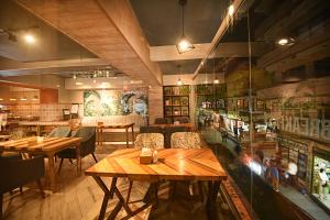 a restaurant with wooden tables and chairs in a room at Daali Hotel & Apartment in Kathmandu