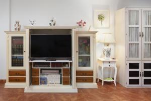 a large entertainment center with a flat screen tv at Villa Jacaranda in Cala del Moral