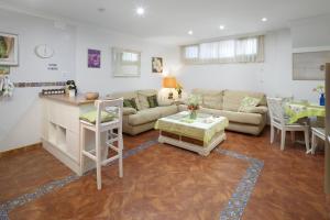 a living room with a couch and a table at Villa Jacaranda in Cala del Moral