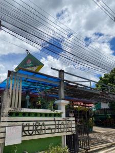 a restaurant with a sign in front of a building at Sakura House in Chiang Mai