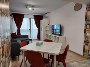 a small living room with a table and chairs at M Suites in Cluj-Napoca