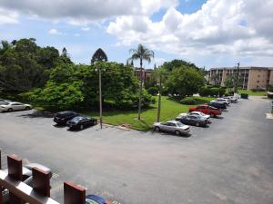 a parking lot with cars parked in front of a building at 4080 Lake Bayshore Drive in Bradenton