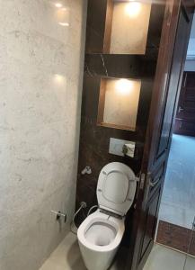 a small bathroom with a toilet and a shower at City Beautiful Home One room Suite in Panchkula