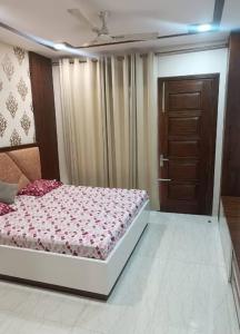 a bedroom with a bed and a brown door at City Beautiful Home One room Suite in Panchkula