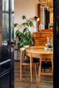 a dining room table and chairs with a plant at Haven 1 in Sint Anna ter Muiden