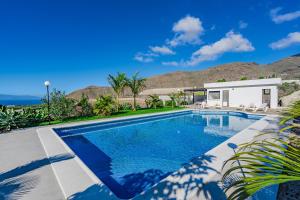 a swimming pool in front of a house at Sea View House Pride & Joy - Adults Only in Santiago del Teide