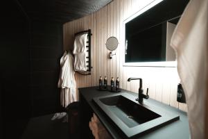 a bathroom with a sink and a mirror at Livo Arctic Resort in Posio +18 photos