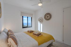 a bedroom with a bed with two towels on it at Sea View House Pride & Joy - Adults Only in Santiago del Teide +52 photos