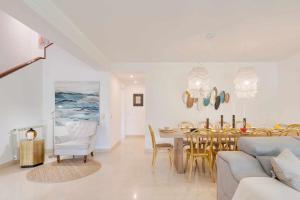 a living room with a table and a dining room at Unique beach Villa with ocean view pool tennis in Cascais