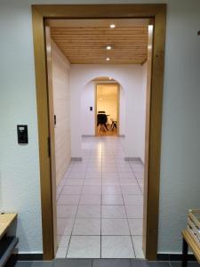 a hallway with a door leading to a piano at Alpenglück Montafon in Sankt Gallenkirch