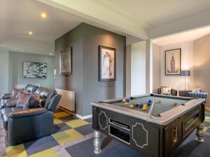 a living room with a pool table and a couch at 9 Bed in Woolverstone 62352 in Freston