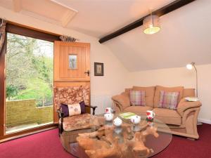 a living room with a glass table and a couch at 1 Bed in Godshill IC146 in Godshill
