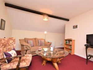 a living room with a couch and a table at 1 Bed in Godshill IC146 in Godshill