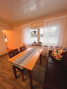 a living room with a wooden table and a window at Frisch renovierte Ferienwohnung in ruhiger Lage in Braunfels +4 photos