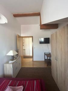 a room with a bed and a desk with a lamp at Apartman Anita in Varaždin