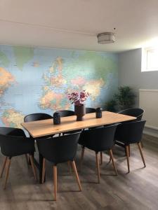 a table and chairs in an office with a map on the wall at STF Malmfältens Folkhögskola in Kiruna