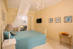 a bedroom with a blue bed and a table with a lamp at Orfeas House Corfu in Corfu Town