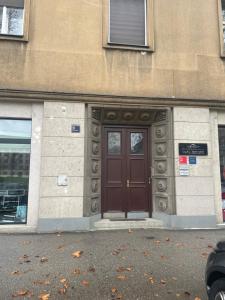 a building with a brown door on the side of it at B&B President in Zagreb
