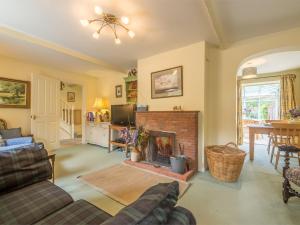 a living room with a fireplace and a tv at 3 Bed in Thornham KT111 in Thornham