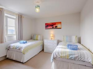 a bedroom with two beds and a window at 3 Bed in Burnham Deepdale KT045 in Burnham Deepdale