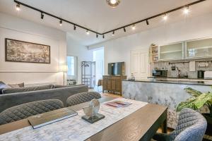 a kitchen and a living room with a table and chairs at Villa Botaniq in Sopron