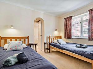 a bedroom with two beds and a window at 3 Bed in Cley-next-the-Sea KT036 in Cley next the Sea