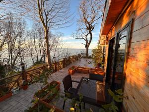 a balcony of a house with a view of the water at Falez Cafe&Restaurant&Pansiyon-Arhavi in Arhavi