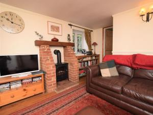 a living room with a couch and a fireplace at 3 Bed in Syderstone KT083 in Syderstone
