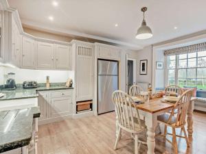a kitchen and dining room with a table and chairs at 4 Bed in Snettisham KT124 in Snettisham