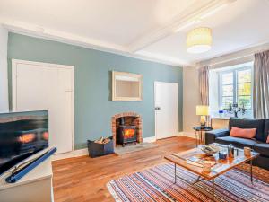 a living room with a couch and a fireplace at 4 Bed in Snettisham KT124 in Snettisham